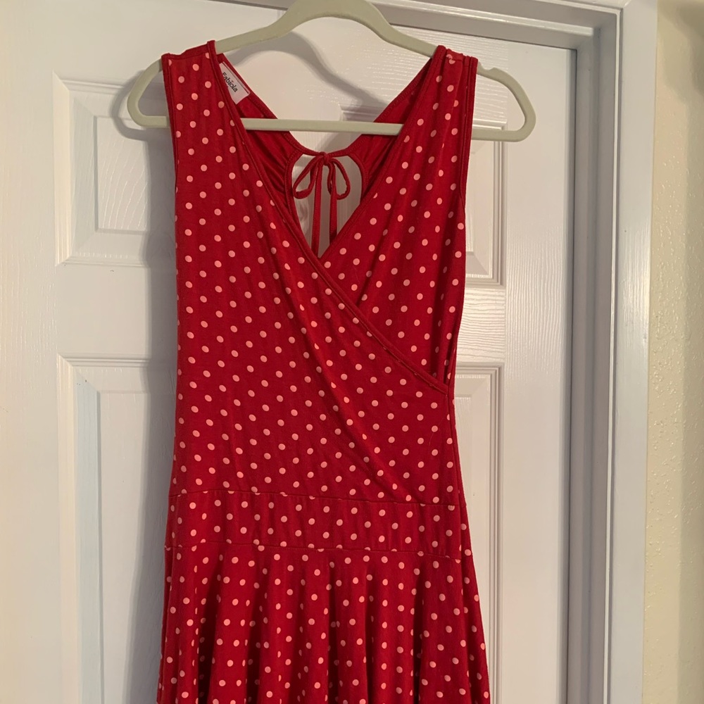 Short red dress with pink polka dots, partial open back.